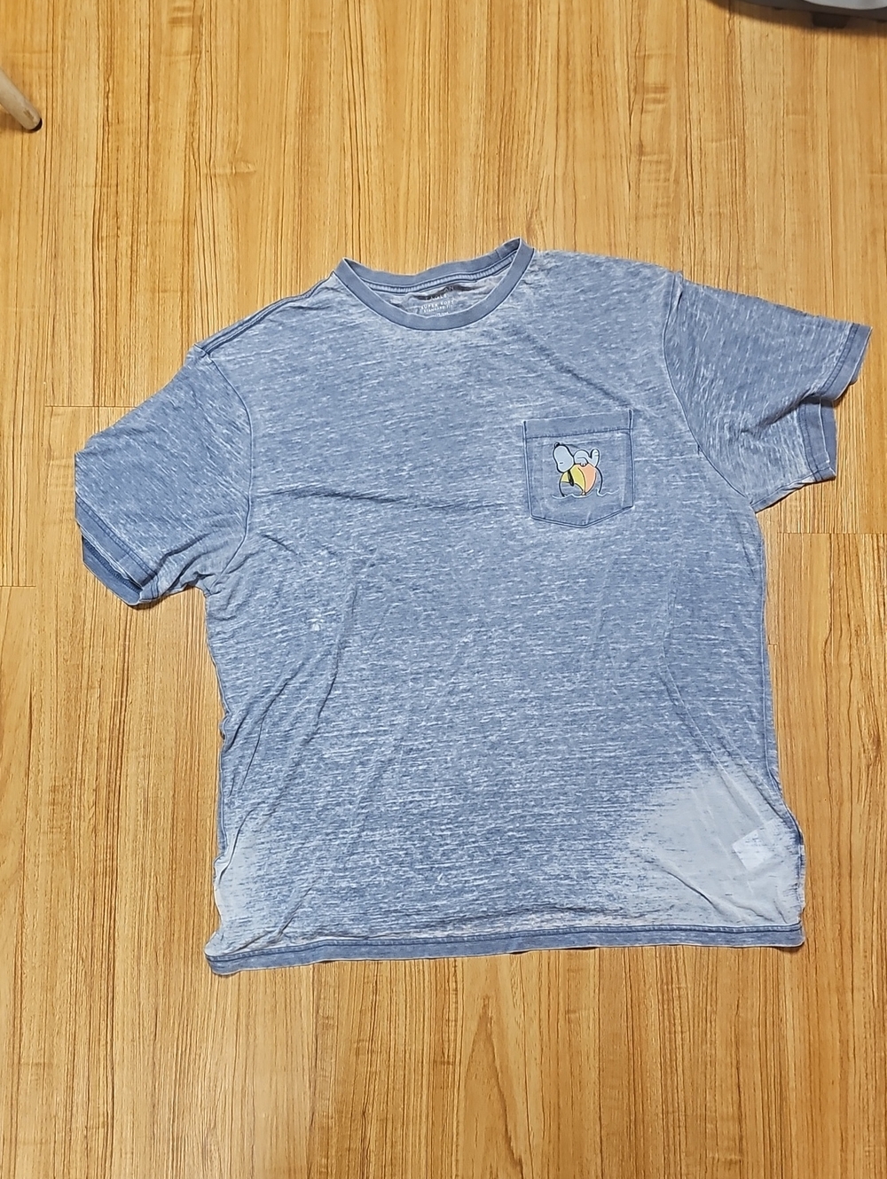 American Eagle Outfitters Light Heather Blue Pocket Tee with Snoopy Graphic.